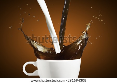 Coffee and Milk Splash from Cup With Coffee Beans Falling
