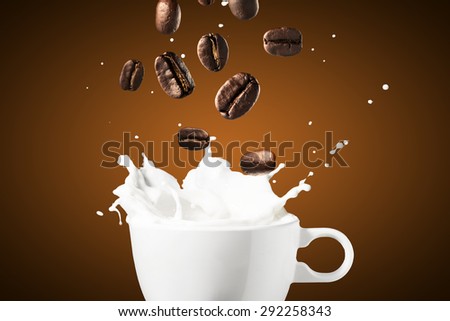 Milk Splash With Coffee Beans Falling Into Cup