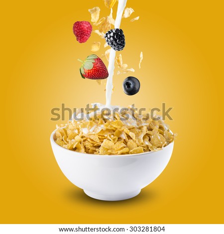 Various Berries Falling Into Bowl of Cereal With Milk Splash