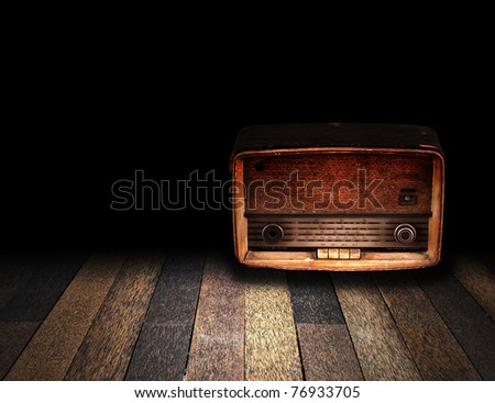 Old room with wooden floor and vintage radio with fade to black background