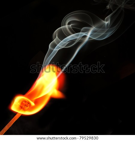 Spark of match with fire and smoke on black background