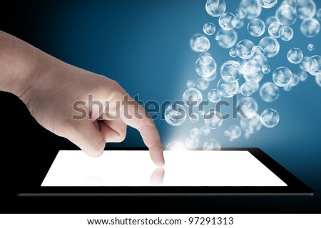 Businessman touch tablet PC screen with globe coming out from the screen. Concept for internet, email, and connectivity
