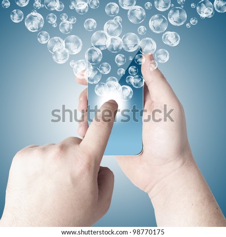 Hands holding and point on touch screen mobile phone with 3D globe icon coming from the screen on blue background
