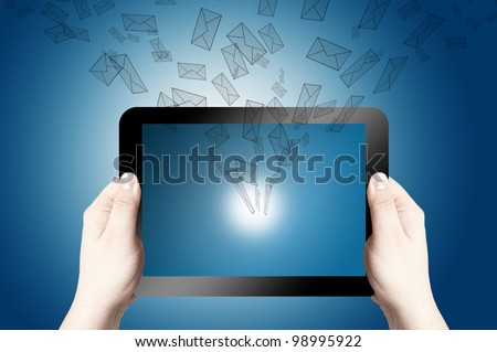 Two hands holding and point on digital tablet with 3D mail icon coming from the screen on blue background