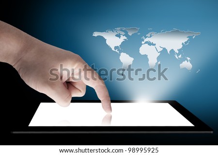 Man\'s finger pointing on the touch screen tablet PC with 3D world map raising from the screen. Concept for connectivity