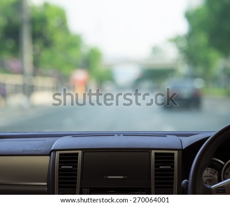 Car dash panel with blurred street background for your design