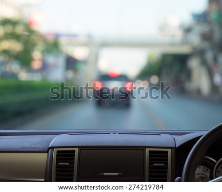 Car dash panel with blurred street background for your design