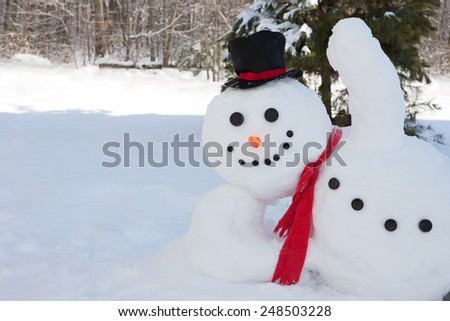 Happy snowman waving his hand