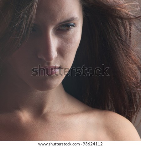 A beautiful girl with developing hairs looking sideways