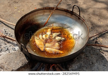 Food fried in oil on an outdoor wood fire in a rural Zanzibar settlement