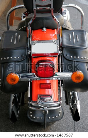Hind view of a red motorcycle with leather bags