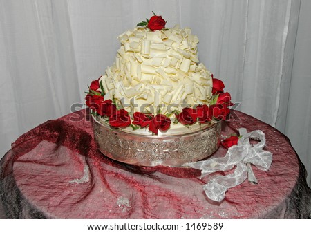 stock photo Wedding cake on table decorated with red roses