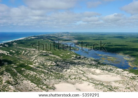 Aerial view of shallow coastal waters and forests of the tropical coast of Mozambique, southern Africa