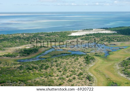 Aerial view of shallow coastal waters and forests of the tropical coast of Mozambique, southern Africa
