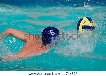 stock photo : Water polo player swimming for the ball