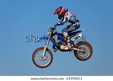 BLOEMFONTEIN, SOUTH AFRICA - JULY 19: Unidentified motocross rider jumps through the air during a national motocross racing event, on Jul 19, 2009 in Bloemfontein, South Africa.