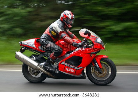 Fast red Italian Motorcycle at speed