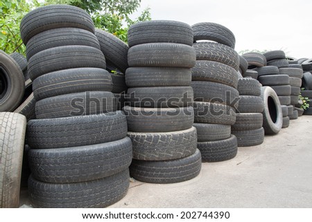 Pile of old tires and wheels for rubber recycling.