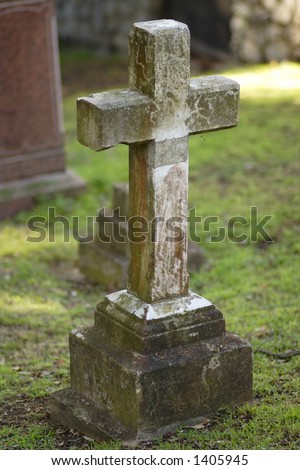 Old cross shaped headstone, DOF focus on cross.