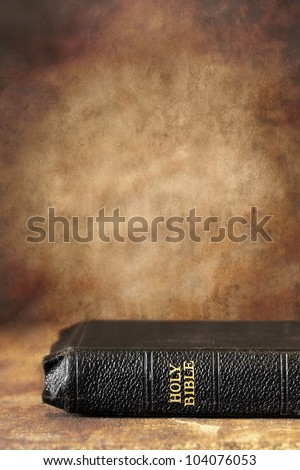 Old Holy Bible, over a grunge stone background.  Lots of copy-space.