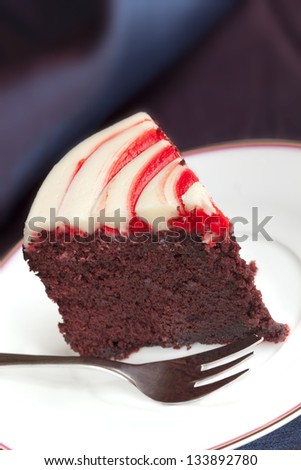 Slice of red velvet cake with cake fork.