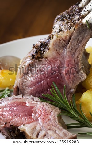 Rack of lamb with rosemary and roasted potatoes.  Tight crop.