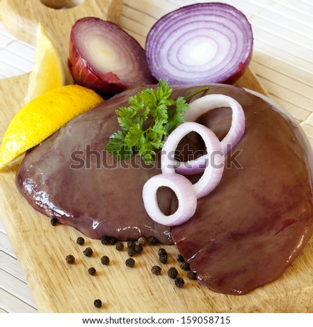 Raw liver with peppercorns, onion and lemon.
