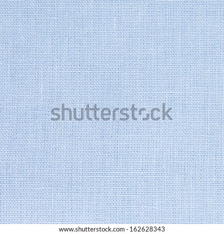 Macro of pastel blue linen fabric.