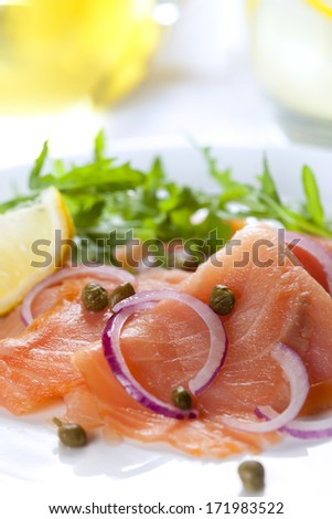 Smoked salmon salad with red onion, capers, lemon and arugula.