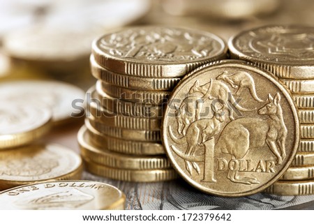Stacks of Australian one dollar coins.  Focus on front coin.