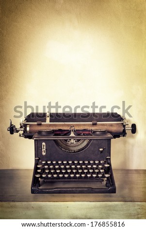 Vintage Typewriter On Old Desk With Grunge Background. Lots Of Copy Space.