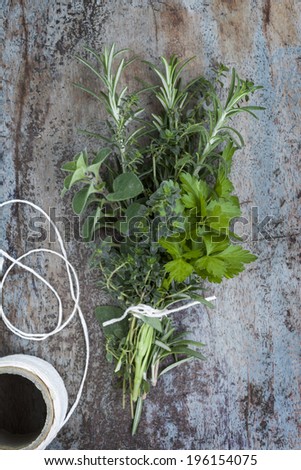 Bouquet garni of fresh herbs, tied with twine.  Rosemary, thyme, oregano, parsley.