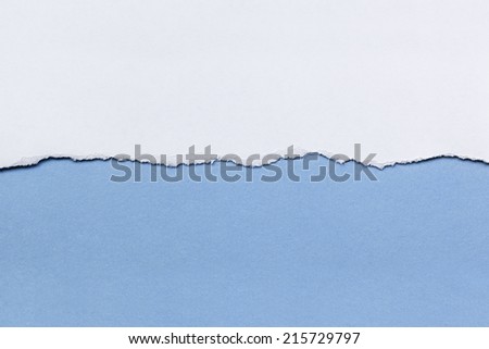Torn white paper over blue background.