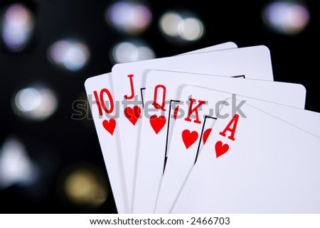 A royal flush, heart suit, with colored light background
