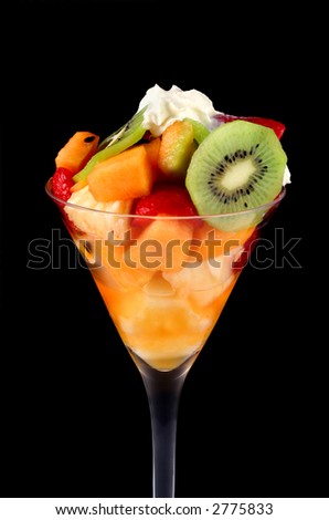 fruit salad with cream. fruit salad and cream in a