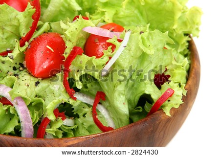 Green salad - a bowl of curly coral lettuce, tiny grape tomatoes, red chili, and spanish onions.
