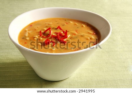 stock photo : A stylish white bowl of thick Laksa soup, topped with red stock photo : A stylish white bowl of thick Laksa soup, topped with red