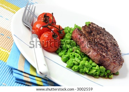 Pepper steak, with roasted vine-ripened cherry tomatoes and a pea mash.