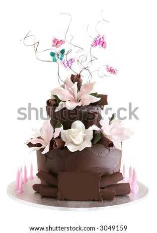 A two-tiered chocolate cake, with flowers, butterflies, and candles.  Blank chocolate plaque for your own message.