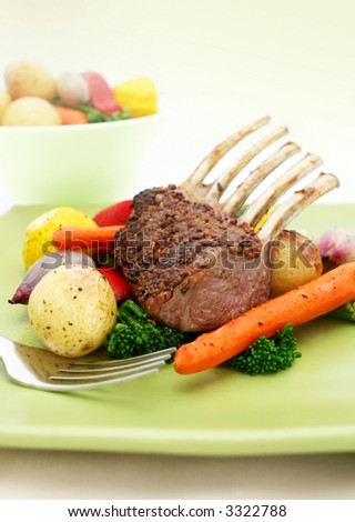 Rack of lamb with whole-grain mustard and rosemary, and colorful roasted vegetables.