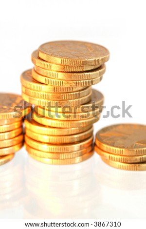 Gold Coins ~ stacks of Australian one dollar coins, with high key effect.  Shallow depth of field.