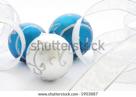 Blue and silver Christmas baubles, with silver ribbon.  Soft focus, shallow depth of field.