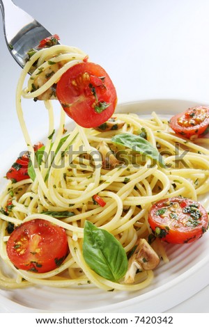 stock-photo-spaghetti-with-pesto-cherry-tomatoes-mushrooms-and-chili-twirled-on-a-fork-7420342.jpg