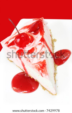 Strawberry cheesecake topped with a cherry and strawberry sauce.  Vibrant cherry-red background.  Yum!