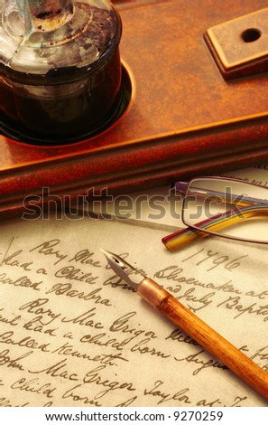 Vintage nib pen and inkwell, on page of 18th Century text.