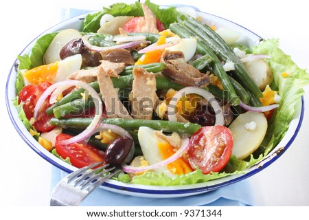Salad nicoise.  Tuna, with green beans, grape tomatoes, eggs, chat potatoes, black olives, anchovies, and a vinaigrette mustard dressing.