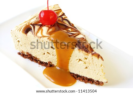 Slice of yummy caramel cheesecake, topped with a cherry and caramel sauce.