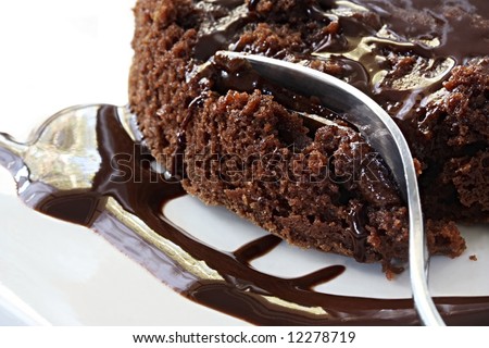 Molten chocolate pudding in close-up view with a dessert fork.