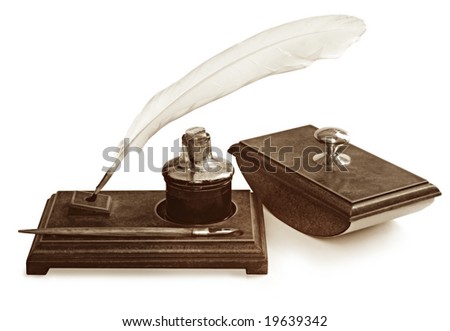 Vintage writing set, including feather quill pen, nib pen, ink well and blotter, on writing stand.  Isolated on white.