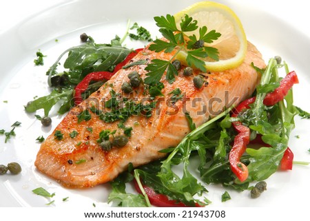 Atlantic salmon with a rocket salad, garnished with lemon, capers and parsley.